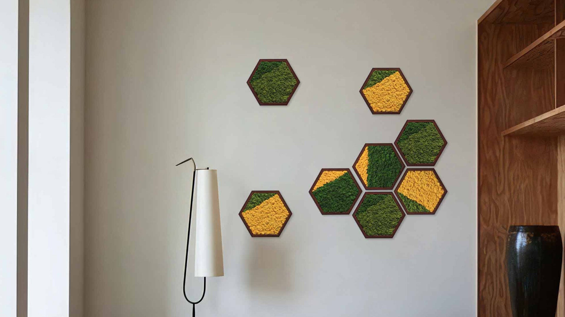 Hexagonal moss wall art set in green and beige tones, decorating a modern living interior