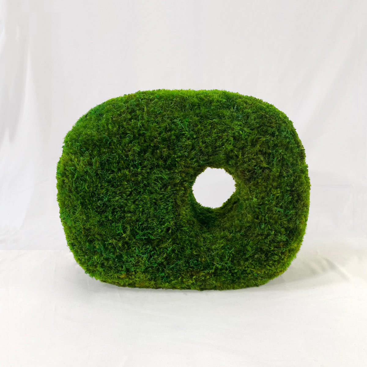 Cube-shaped moss sculpture with totemic guardian features